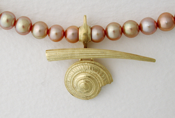 A tusk shell and spiral shell in 18K gold on pink Fresh Water Pearls